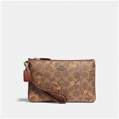 Small Wristlet In Signature Canvas With Floral Bow Print .